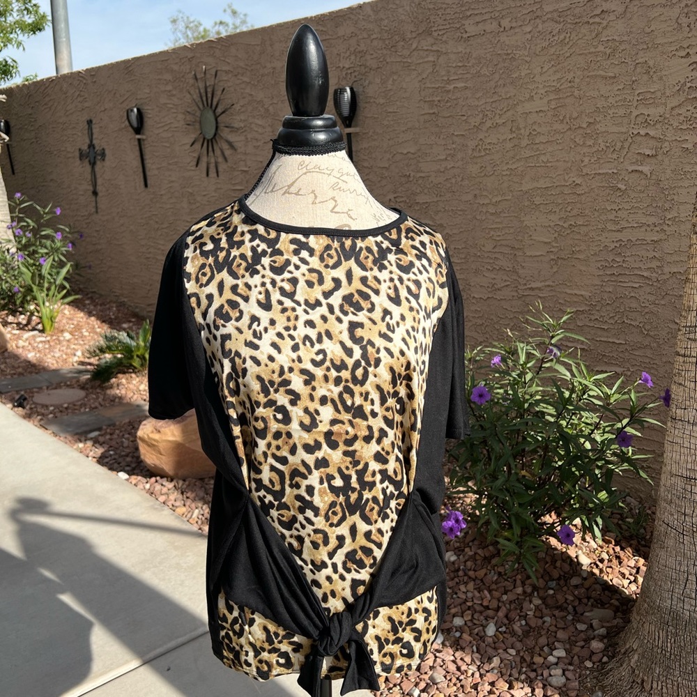 Leopard print top with ties at waist. New without tags. Size L.